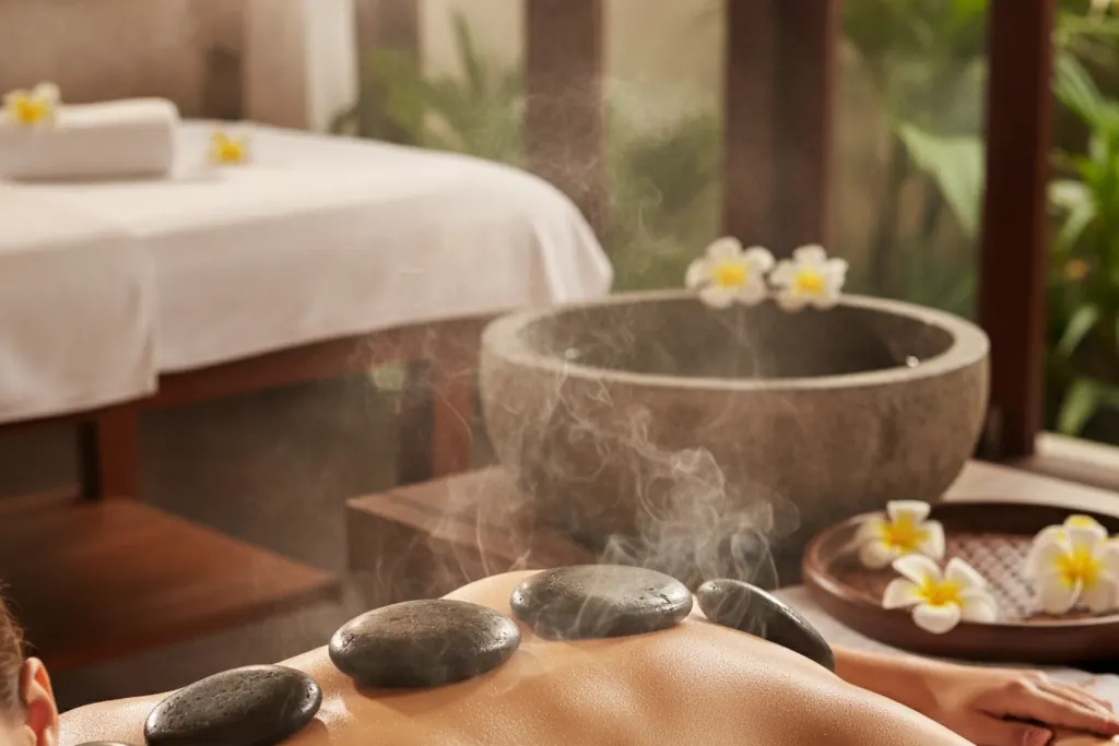 Hot stone massage: warm basalt stones aligned on the back