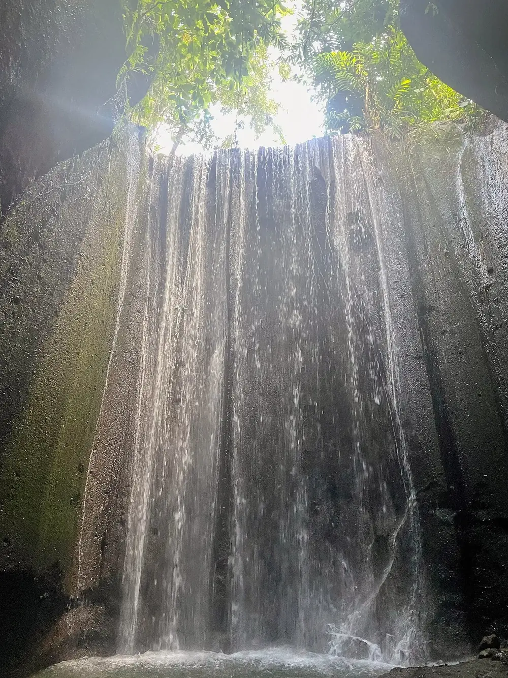 A cave waterfall, the light beam hits around 10am — Tukad Cepung, While you're in Sidemen